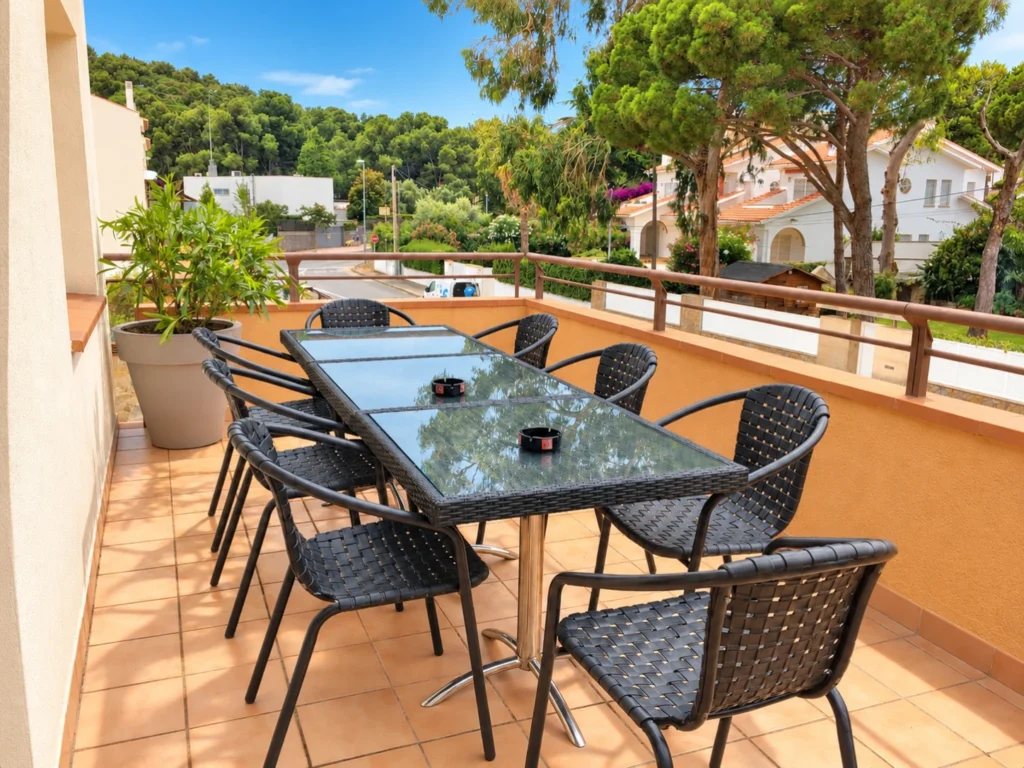 Terrasse mit großem Esstisch vor der Pinienwaldkulisse — Ferienwohnung Miró, La Fosca Bay (Palamós, Costa Brava)